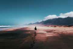 photo of person walking on deserted island
